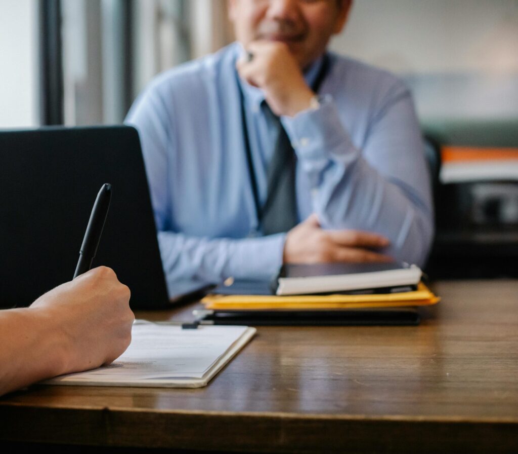 pexels-photo-5668858-5668858 Crop anonymous female filling questionnaire when applying for job sitting in employer office